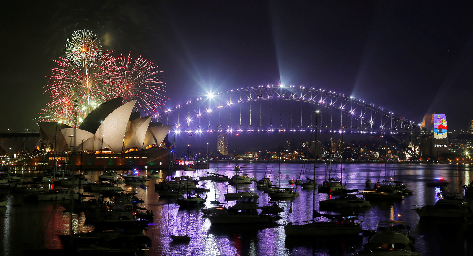 Fireworks explode over the Sydney Opera House and Harbour Bridge during an early evening display in the lead up to the main New Year's Eve fireworks in Sydney, Australia, December 31, 2016.  REUTERS/Jason Reed