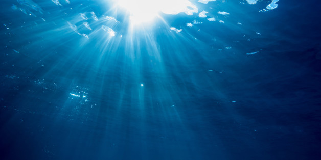 Rays of light cross the waterline in a tropical beach