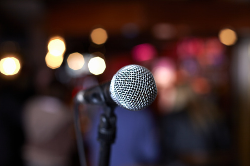 close up of microphone on stage in lights