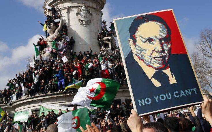 Demonstrators stage a protest to denounce President Abdelaziz Bouteflika's bid for a fifth term on Place de la Republique in Paris, Sunday, March 10, 2019. The protesters are challenging Bouteflika's fitness to run for a fifth term in next month's election. (AP Photo/Francois Mori)