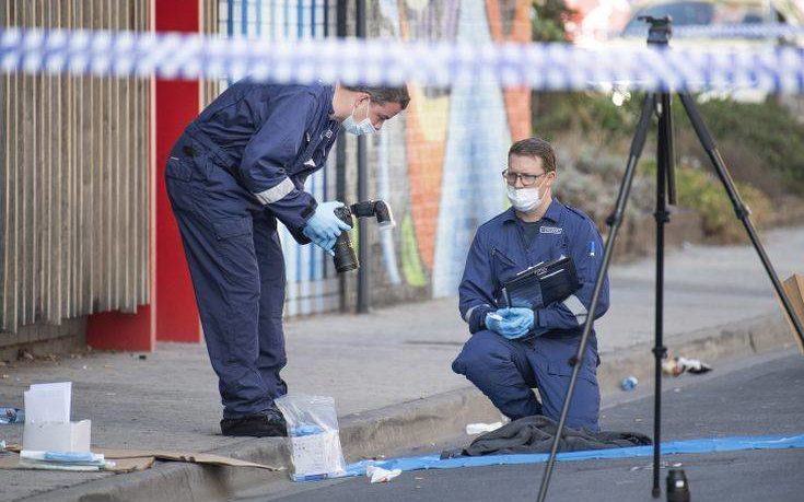 Forensic police examine items at the scene of a multiple shooting outside Love Machine nightclub in Melbourne, Sunday, April 14, 2019.  A shooting outside the nightclub early Sunday left at least two people critically wounded, police said. (Ellen Smith/AAP Image via AP)