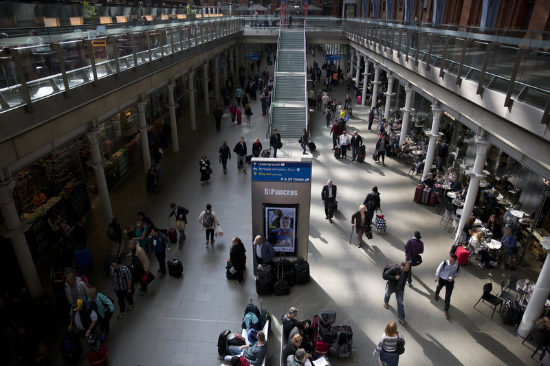 People move through St Pancras international train station in London, Wednesday, Sept. 2, 2015. Hundreds of Eurostar train passengers trying to travel under the English Channel were stranded in France after migrants climbed on tracks overnight in the port city of Calais, officials said. Eurostar trains were resuming normal traffic Wednesday morning. (AP Photo/Matt Dunham)