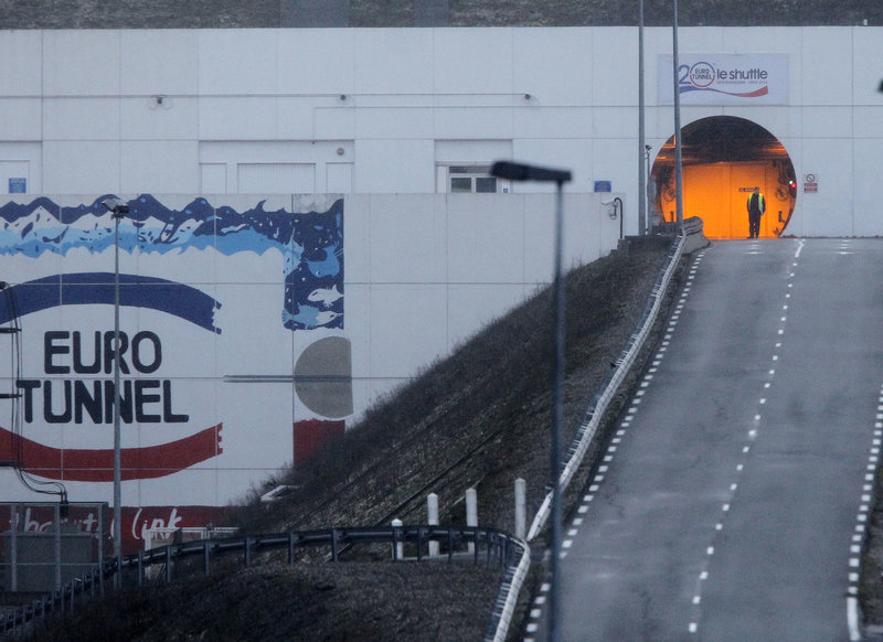 A railway worker is seen as he walks past the entrance to the Channel Tunnel near Calais. in Coquelles, Saturday, Jan.17, 2015. The Channel Tunnel is closed and services hit after lorry fire. (AP Photo/Michel Spingler)