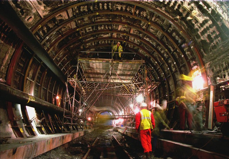 Workers look at the burned out ceiling of the Channel Tunnel, Thursday Dec 5, 1996 estimating the extent of damages for the future restoration caused by last November 18,1996 fire in Calais , northern France.(AP PHOTO/Michel Spingler)