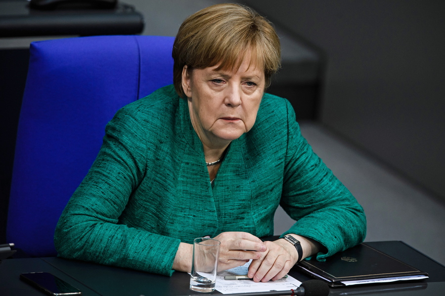 epa06846415 German Chancellor Angela Merkel  sits on the government bench after her speech to the German Bundestag in Berlin, Germany, 28 June 2018. Merkel delivered a government declaration to the members of the German parliament Bundestag prior a meeting of the European Council on 28 and 29 June and the NATO summit on 11 and 12 July 2018.  EPA/CLEMENS BILAN