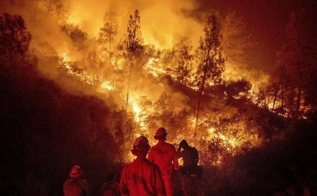 FILE - In this Aug. 7, 2018 file photo, firefighters monitor a backfire while battling the Ranch Fire, part of the Mendocino Complex Fire near Ladoga, Calif. A nationwide telecommunications company that slowed internet service to firefighters as they battled the largest wildfire in California history says it has removed all speed cap restrictions for first responders on the West Coast. Verizon Senior Vice President Mike Maiorana says the service restrictions were removed as of Thursday, Aug. 23, 2018, and include Hawaii, where emergency crews have rescued people from areas flooded by Hurricane Lane. (AP Photo/Noah Berger, File)