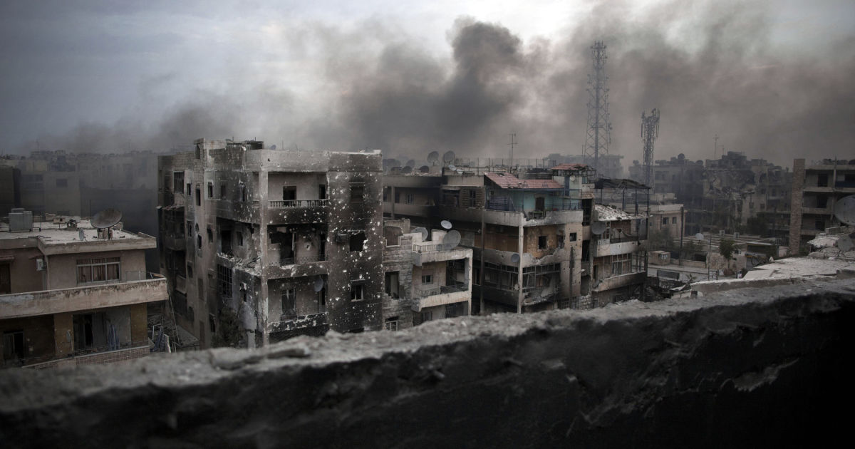 FILE - In this Oct. 2, 2012 file photo, smoke rises over Saif Al Dawla district, in Aleppo, Syria. The United States is outlining no change in its Syria policy as an August 1 target date for a political transition passes. In May, Secretary of State John Kerry issued an Aug. 1 ultimatum to Syrian President Bashar Assad's government and its main backer, Russia. "Either something happens," he said, "or they are asking for a very different track." But on Monday, Kerry said the U.S. would continue its effort to "get a cessation of hostilities in place that is meaningful." (AP Photo/ Manu Brabo, File)