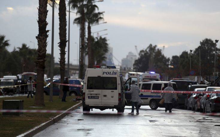 Police forensic officers work at the scene of an explosion, in Izmir, Turkey, Thursday, Jan. 5, 2017. Suspected Kurdish militants on Thursday opened fire at police who stopped them at a checkpoint in the western city of Izmir before detonating their explosives-laden vehicle and escaping, the province's governor said. A policeman and a courthouse employee were killed in the attack while two assailants were shot dead. (AP Photo/Emre Tazegul)