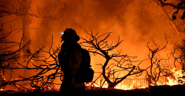 Firefighters battle a wind-driven wildfire called the Saddle Ridge fire in the early morning hours Friday in Porter Ranch, California, U.S., October 11, 2019.  REUTERS/Gene Blevins