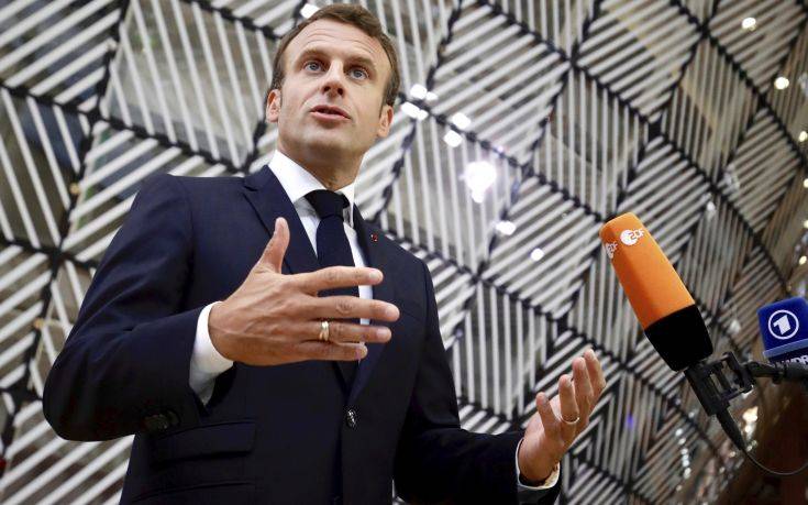 French President Emmanuel Macron speaks with the media as he arrives for an EU summit in Brussels, Sunday, June 30, 2019. European Union leaders have started another marathon session of talks desperately seeking a breakthrough in a diplomatic fight over who should be picked for a half dozen of jobs at the top of EU institutions. (AP Photo/Olivier Matthys)