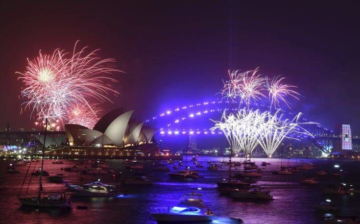 Fireworks are seen from Mrs. Macquarie's Chair during New Year's Eve celebrations in Sydney, Tuesday, Dec. 31, 2019. (Mick Tsikas/AAP Image via AP)