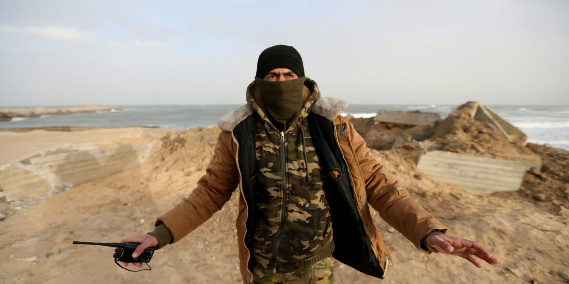 A Palestinian militant gestures at the site of an Israeli air strike in the southern Gaza Strip December 26, 2019. REUTERS/Ibraheem Abu Mustafa