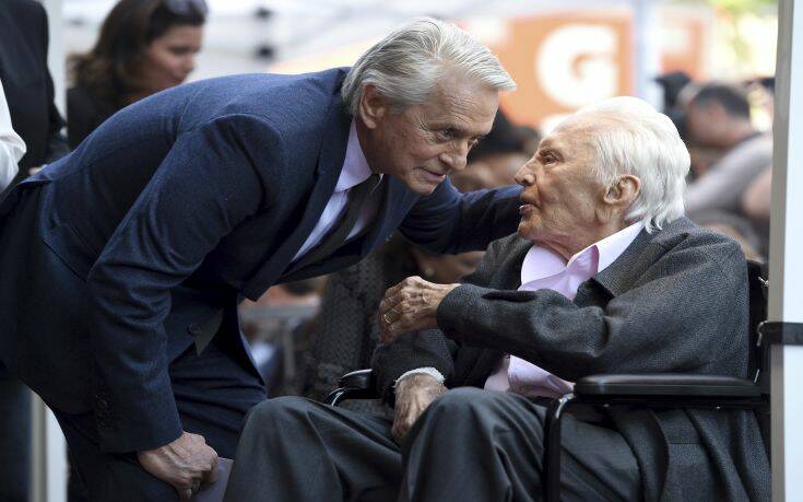 Honoree Michael Douglas, left, speaks with his father Kirk Douglas before a Hollywood Walk of Fame star ceremony on Tuesday, Nov. 6, 2018, in Los Angeles. (Photo by Chris Pizzello/Invision/AP)