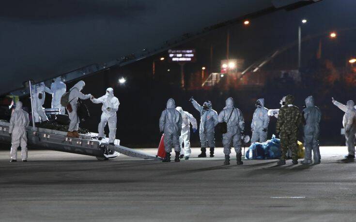 In this image provided by the Turkish Ministry of Health, medical personnel work around a ambulance plane commissioned from the military at the airport in Ankara, Turkey, late Saturday, Feb. 1, 2020, shortly after it landed after flying from Wuhan, China. The Turkish government evacuated 42 people amidst the gathering nationwide concern on Coronavirus.Fahrettin Koca, Turkish Minister of Health said that among the 42 passengers 32 of them are Turkish, 6 are Azerbaijani, 3 are Georgian and one is Albanian. The evacuated passengers will be kept under quarantine for 14 days and will be subject to periodic analysis. (Huseyin Avci/Turkish Ministry of Health via AP)