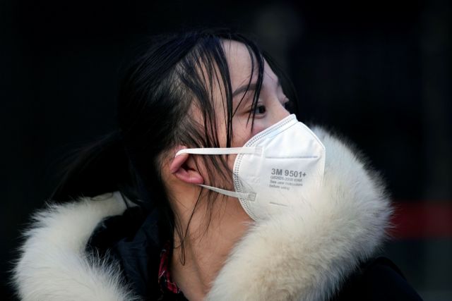 A woman wearing a mask is seen upon her arrival at Shanghai railway station in Shanghai, China, as the country is hit by an outbreak of a new coronavirus, February 2, 2020. REUTERS/Aly Song