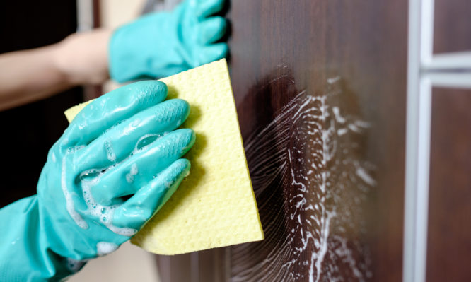 Cleaning house furniture with yellow cloth and detergent