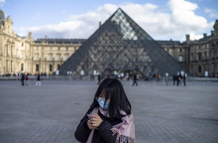 epa08292925 A person wearing protective face mask passes by the Louvre Museum in Paris, France, 13 March 2020. France will ban all gatherings of more than 100 people due to the coronavirus pandemic, French Prime Minister Philippe announced on 13 March 2020. President Macron announced the closing of schools, high schools and nurseries from 16 March 2020 on. Over 2,870 cases of COVID-19 infections and 61 deaths have been confirmed so far in France, reports state.  EPA/YOAN VALAT