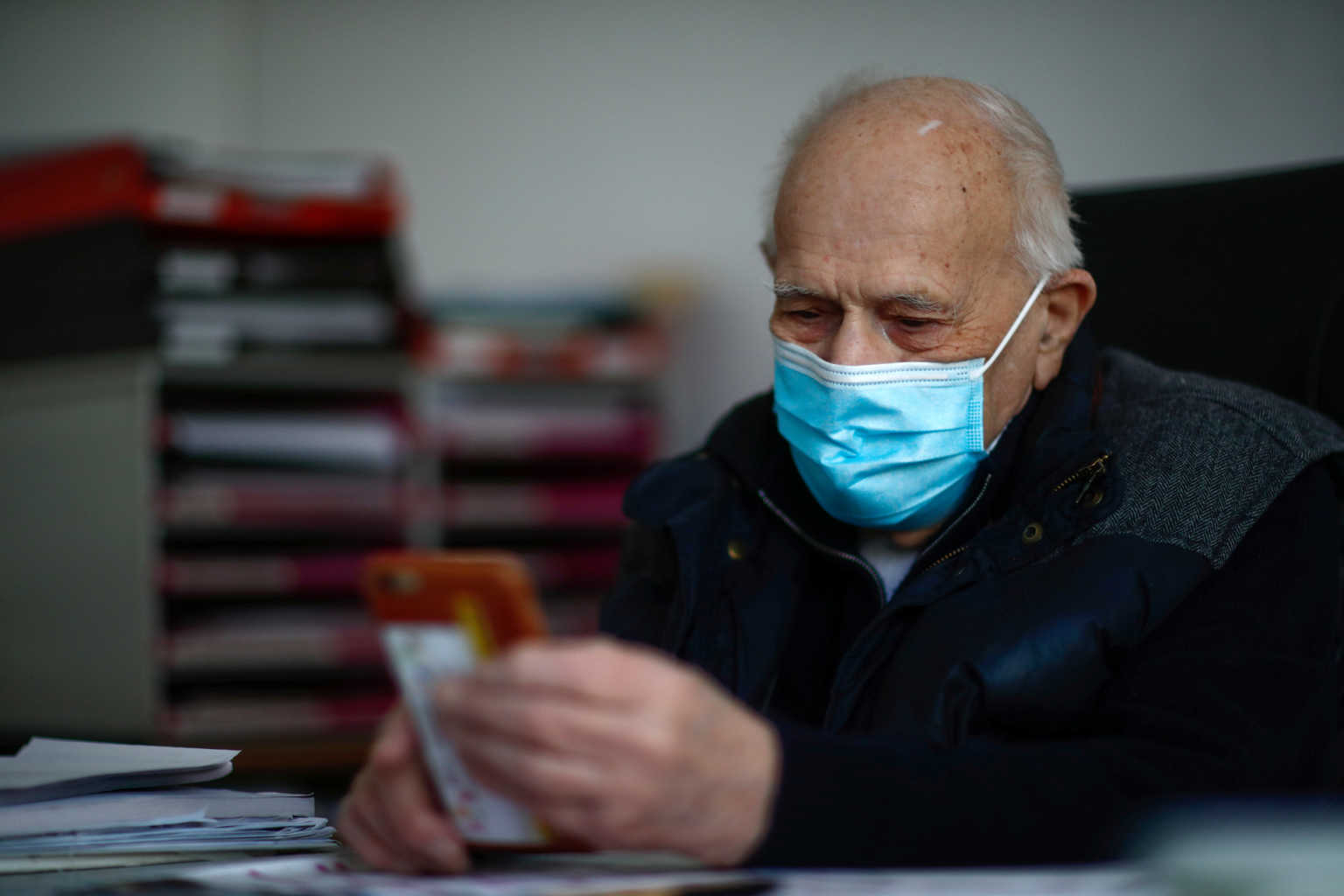 French doctor Christian Chenay, 98 year-old, wearing a protective face mask, sits in his consulting room at the doctor's office in Chevilly-Larue near Paris as the spread of the coronavirus disease (COVID-19) continues in France April 14, 2020. Picture taken April 14, 2020. REUTERS/Gonzalo Fuentes