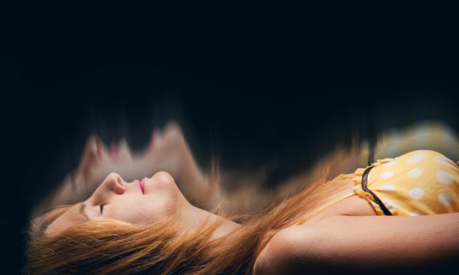 A concept image of a sleeping woman having a nightmare.