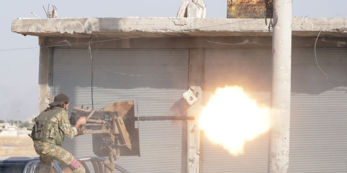 A Turkey-backed Syrian rebel fighter fires a weapon in the town of Tal Abyad, Syria October 13, 2019. REUTERS/Khalil Ashawi