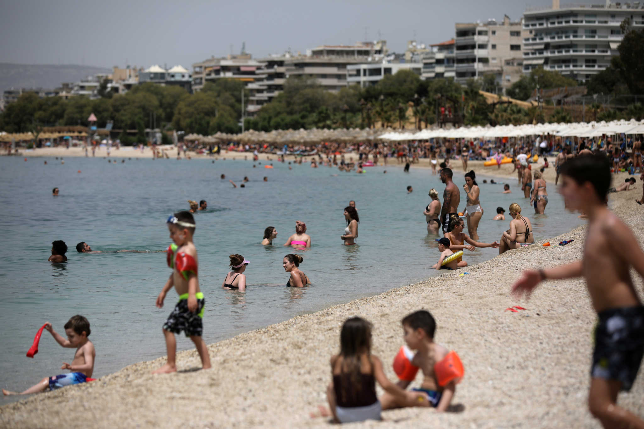 People enjoy the sun during the official reopening of beaches to the public following the easing of measures against the spread of the coronavirus disease (COVID-19), in Athens, Greece, May 16, 2020. REUTERS/Costas Baltas