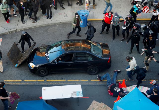 A man falls after being shot by a driver who tried to drive through a protest against racial inequality in the aftermath of the death in Minneapolis police custody of George Floyd, in Seattle, Washington, U.S. June 7, 2020. REUTERS/Lindsey Wasson     TPX IMAGES OF THE DAY