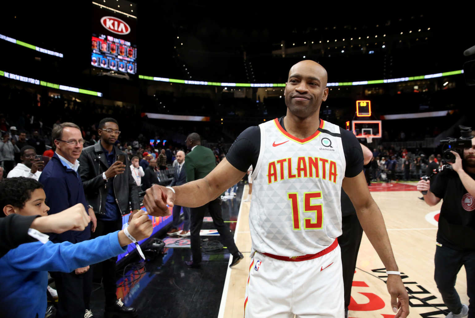 Mar 11, 2020; Atlanta, Georgia, USA; Atlanta Hawks guard Vince Carter (15) fist bumps fans after an overtime loss to the New York Knicks at State Farm Arena. Mandatory Credit: Jason Getz-USA TODAY Sports