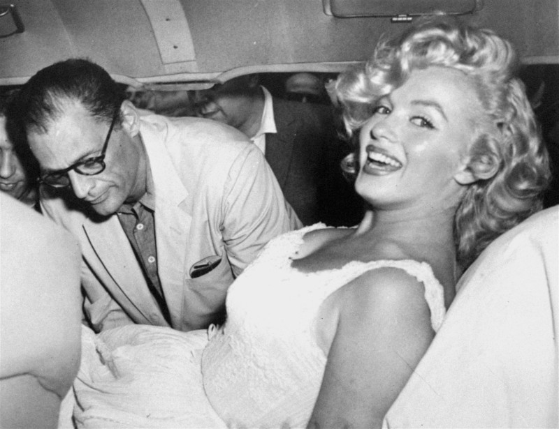 Marilyn Monroe is made comfortable in a car by her husband, playwright Arthur Miller, following her release from Doctors Hospital, New York City, August 10, 1957.  Marilyn was hospitalized for a miscarriage and spent 10 days in the hospital. (AP Photo)