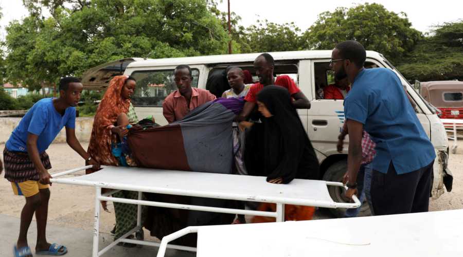 Civilians assist an injured person at Madina hospital after a blast at the Elite Hotel in Lido beach in Mogadishu, Somalia August 16, 2020. REUTERS/Feisal Omar