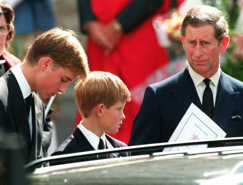 Prince Charles, the former husband of Diana, Princess of Wales, and their two sons Harry, centre, and William wait in front of Westminster Abbey in London after the funeral ceremony of the Princess, Saturday September 6, 1997. The body of the Princess Diana who died in a Paris car crash the previous Sunday was transported to a grave in her family estate following the funeral. (AP Photo/ Joel Robine/Pool)