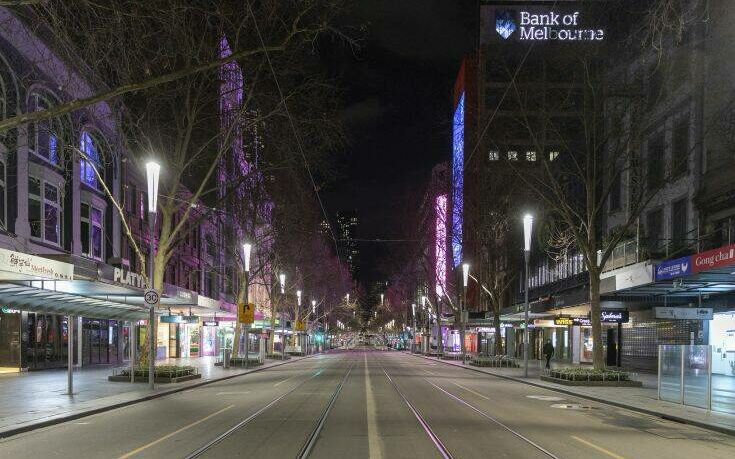 An empty Swanston Street is seen at night in the Central Business District as lockdown due to the continuing spread of COVID-19 prepares to start Wednesday, Aug. 5, 2020, Melbourne. Victoria state, Australia's coronavirus hot spot, announced on Monday that businesses will be closed and scaled down in a bid to curb the spread of the virus. (AP Photo/Asanka Brendon Ratnayake)