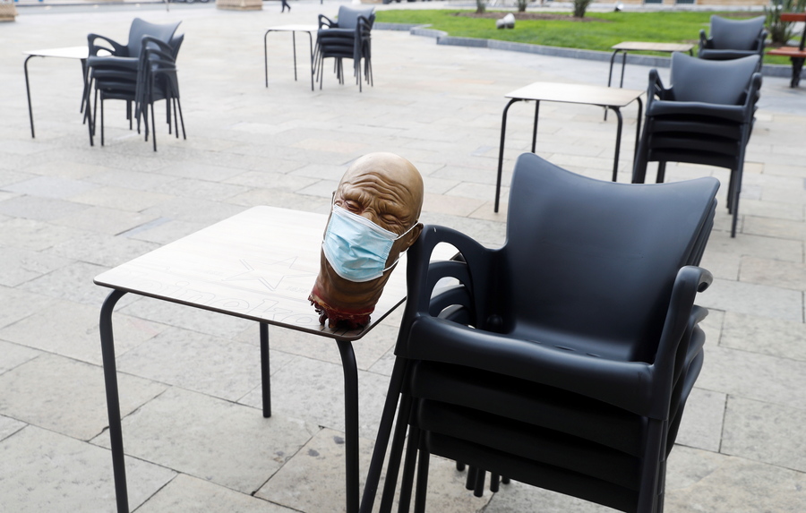 epa08802333 A rubber head with a facial mask is seen on the table at a bar terrace in San Sebastian, Spain, 06 November 2020. The Basque regional Goverment has ordered the closure of bars and restaurants and will set a curfew at 22.00 hrs from 07 November 2020 in a bid to reduce coronavirus spread and in an attempt to avoid a complete lockdown.  EPA/Javier Etxezarreta