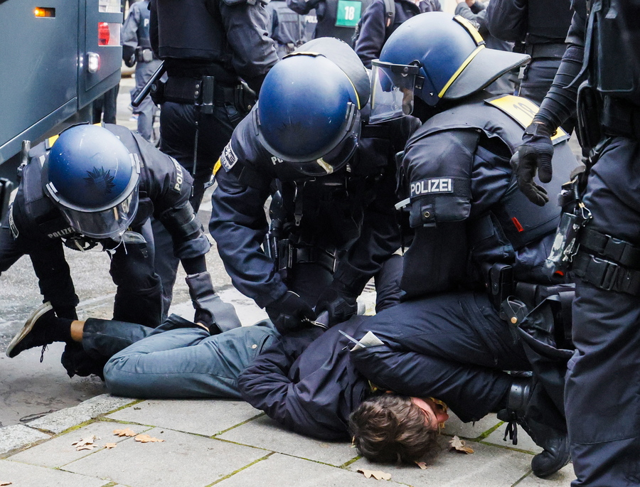 epa08819921 Riot police officers arrest a left-wing protester aside a demonstration against the coronavirus restrictions, in Frankfurt am Main, Germany, 14 November 2020. The protests organized by the Third Position movement 'Querdenken' were held against government-imposed semi-lockdown measures aimed at curbing the spread of the coronavirus pandemic. Starting 02 November, all restaurants, bars, cultural venues, fitness studious, cinemas and sports halls will be forced to close for four weeks as a lockdown measure to rein in skyrocketing coronavirus infection rates.  EPA/RONALD WITTEK