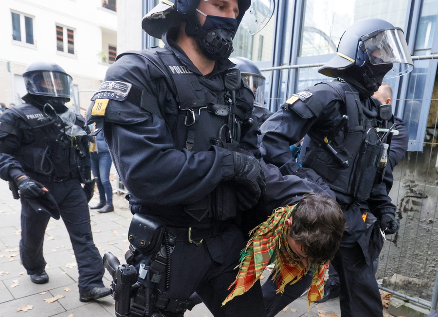 epa08819922 Riot police officers detain a left-wing protester aside a demonstration against the coronavirus restrictions, in Frankfurt am Main, Germany, 14 November 2020. The protests organized by the Third Position movement 'Querdenken' were held against government-imposed semi-lockdown measures aimed at curbing the spread of the coronavirus pandemic. Starting 02 November, all restaurants, bars, cultural venues, fitness studious, cinemas and sports halls will be forced to close for four weeks as a lockdown measure to rein in skyrocketing coronavirus infection rates. EPA/RONALD WITTEK