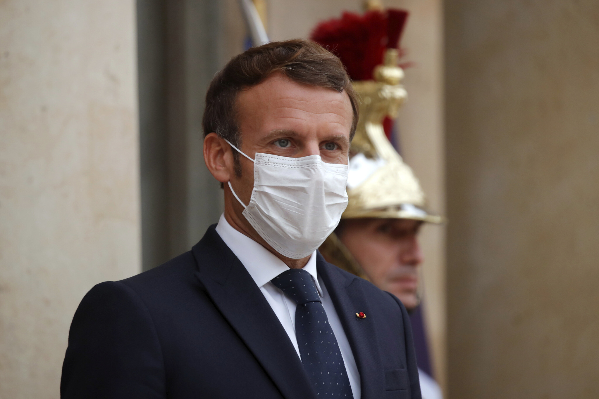 French President Emmanuel Macron, left, wearing a protective face mask, waits to welcome Armenian President Armen Sarkissian for a meeting at the Elysee Palace in Paris, Thursday, Oct. 22, 2020. (Charles Platiau/Pool via AP)