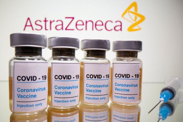 FILE PHOTO: Vials with a sticker reading, "COVID-19 / Coronavirus vaccine / Injection only" and a medical syringe are seen in front of a displayed AstraZeneca logo in this illustration taken October 31, 2020. REUTERS/Dado Ruvic/Illustration/File Photo