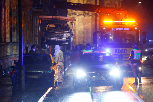 Police officers and workers remove the vehicle involved in the incident at the city center, where a car crashed into pedestrians in Trier, Germany, December 1, 2020. REUTERS/Thilo Schmuelgen