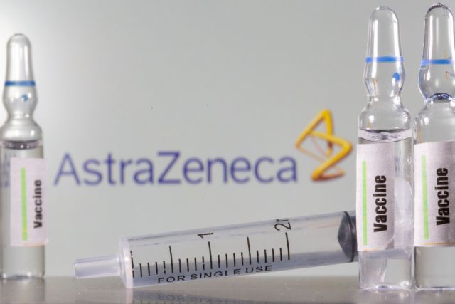 FILE PHOTO: A test tube labelled with the word Vaccine is seen in front of AstraZeneca logo in this illustration taken, September 9, 2020. REUTERS/Dado Ruvic/Illustration/File Photo