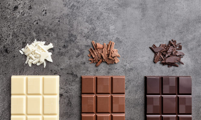 Delicious and sweet variety of chocolate on rustic background