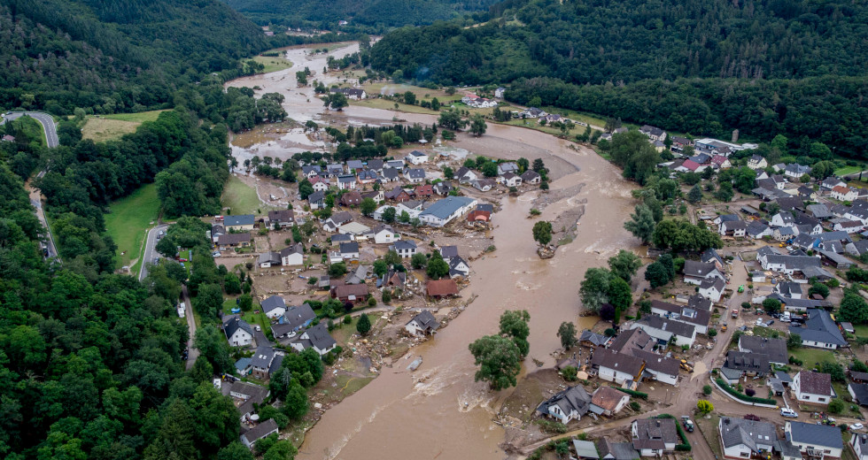 The Ahr river floats past destroyed houses in Insul, Germany, Thursday, July 15, 2021. Due to heavy rain falls the Ahr river dramatically went over the banks the evening before. (AP Photo/Michael Probst)