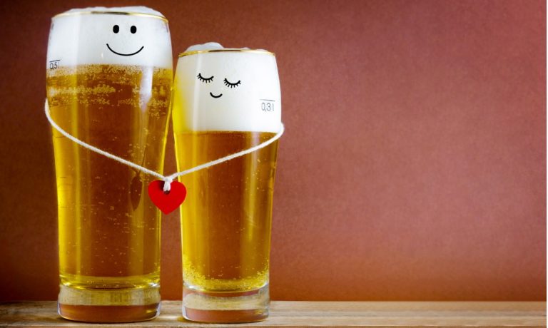 two-glasses-of-beer-with-painted-happy-couple-and-red-heart-on-bar-picture-id1281760360-768x460