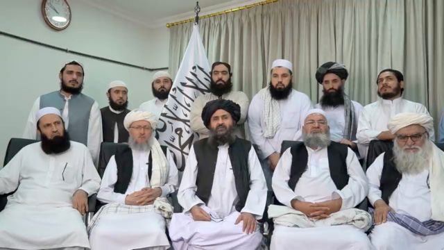 Mullah Baradar Akhund, a senior official of the Taliban, seated with a group of men, makes a video statement, in  this still image taken from a video recorded in an unidentified location and released on August 16, 2021. Social Media/via REUTERS  THIS IMAGE HAS BEEN SUPPLIED BY A THIRD PARTY.