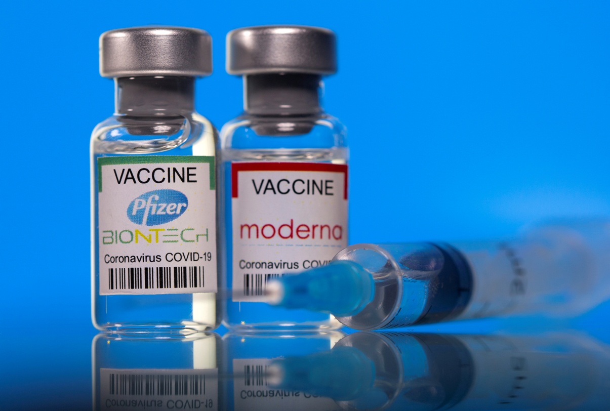 FILE PHOTO: Vials with Pfizer-BioNTech and Moderna coronavirus disease (COVID-19) vaccine labels are seen in this illustration picture taken March 19, 2021. REUTERS/Dado Ruvic