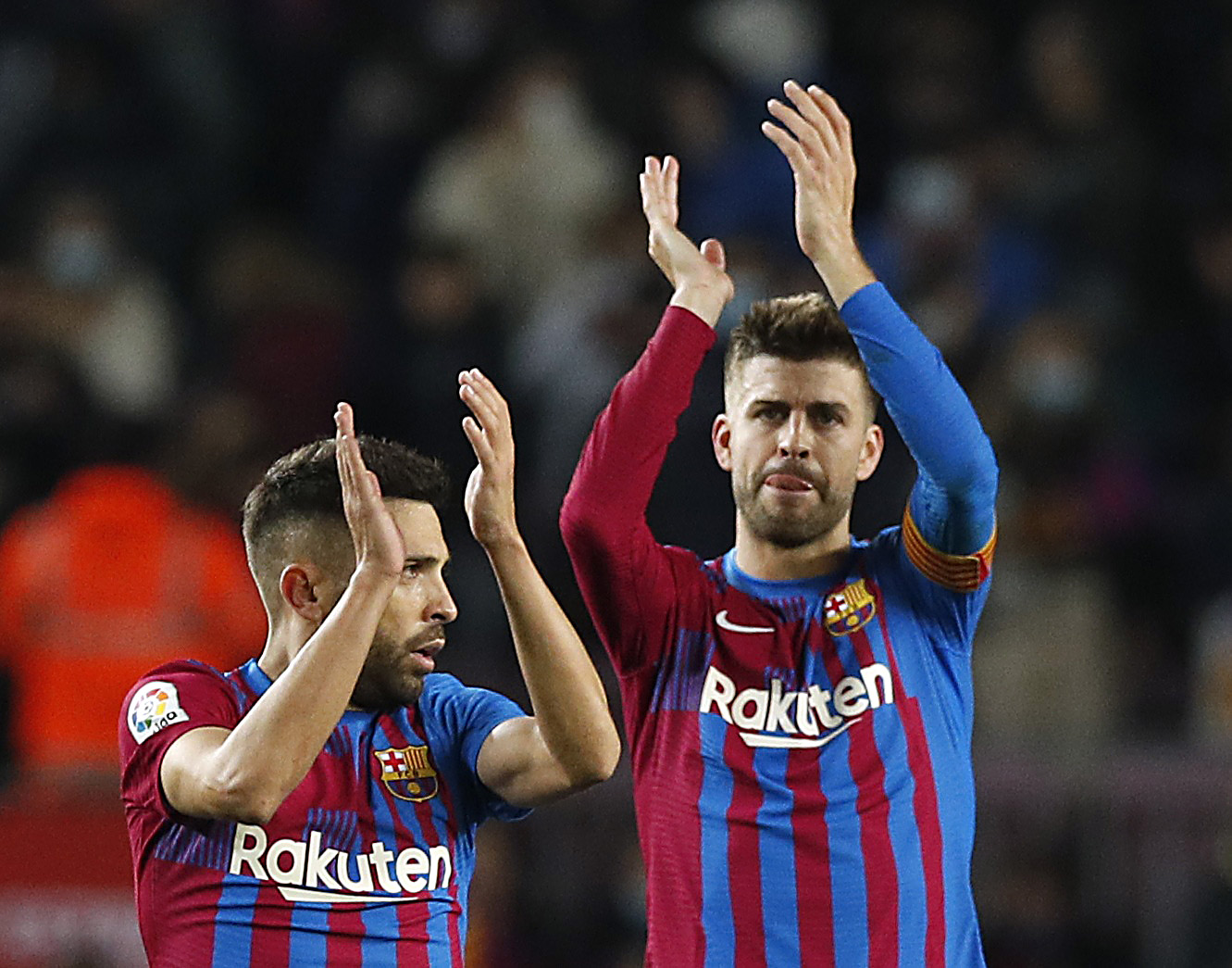 Soccer Football - LaLiga - FC Barcelona v Espanyol - Camp Nou, Barcelona, Spain - November 20, 2021  FC Barcelona's Jordi Alba and Gerard Pique applauds fans after the match REUTERS/Albert Gea