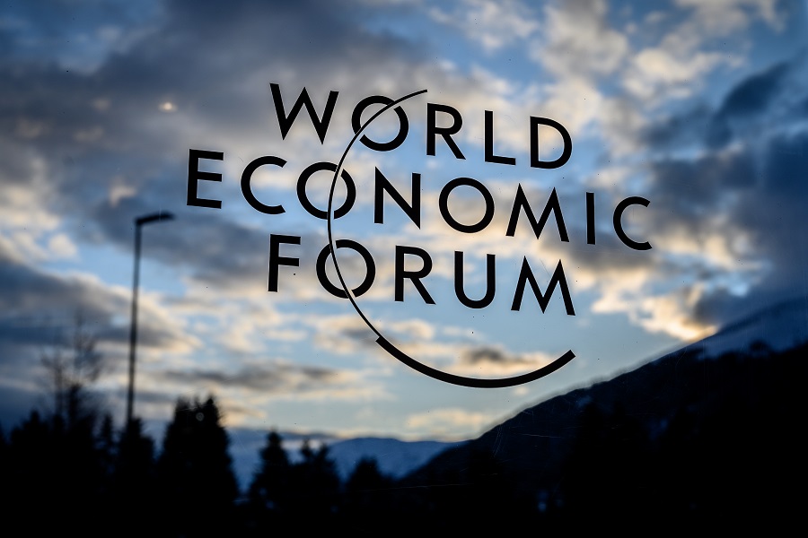 A sign fo the World Economic Forum (WEF) is seen at sunset in the Congress center ahead of the annual meeting of the World Economic Forum (WEF) in Davos on January 19, 2020. (Photo by Fabrice COFFRINI / AFP)