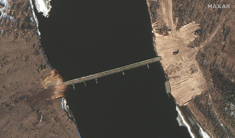 Satellite images taken over the past two days show new road construction and a tactical bridge being built across a key river in Belarus less than four miles from the Ukrainian border, amid what sources say is an ongoing buildup of Russian military forces encircling three sides of Ukraine.

Western intelligence and military officials are closely tracking the construction as part of the support infrastructure Russia is putting in place in advance of a potential invasion, three sources familiar with the matter told CNN. 

Both the new road construction and the bridge, across the Pripyat River in southern Belarus, are less than 4 miles from the border and could be used by Russian forces currently in Belarus in a drive to Kyiv, the Ukrainian capital. The satellite images, from Maxar and Planet, show the appearance of the pontoon bridge virtually overnight on Tuesday.