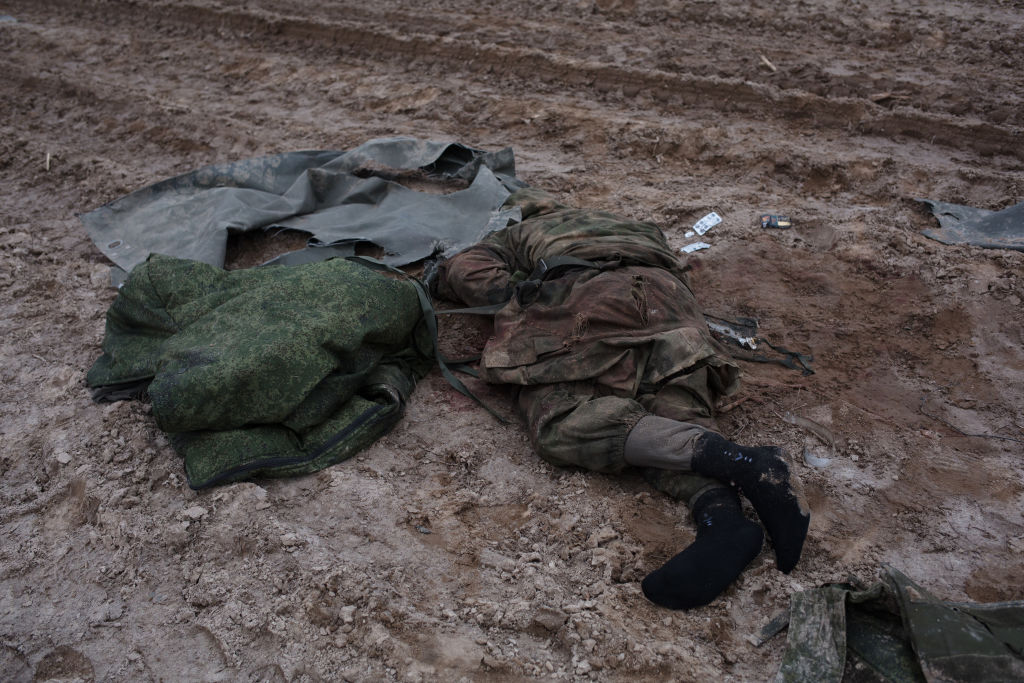 SYTNIAKY, UKRAINE - MARCH 05: (EDITORS' NOTE: Image contains graphic content) A view to a dead body of a Russian soldier lying on the road on March 5, 2022 in Sytniaky, Ukraine. Russia continues assault on Ukraine's major cities, including the capital Kyiv, more than a week after launching a large-scale invasion of the country. (Photo by Anastasia Vlasova/Getty Images)