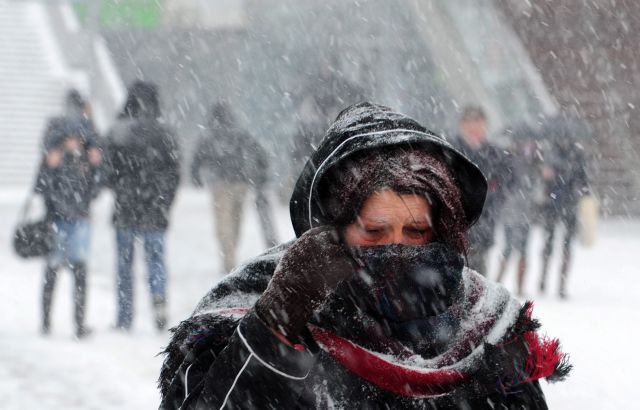 epa03094577 A woman has wrapped herself into her coat and scarf as she walk during snowfall in a street in central Skopje, capital of The Former Yugoslav Republic of Macedonia (FYROM), on 06 February 2012. An usual heavy snowfall hit Macedonia early morning followed by Siberian cold. Temperature during the fell to minus 16 degrees Celsius. A cold wave sweeping across Europe has killed more than 420 people since late January, many of them homeless, and weather reports on 06 February forecast more snow and frigid temperatures for the upcoming days. The snow has thrown transportation out of gear, blocked arterial roads and cut off remote villages in many areas.  EPA/GEORGI LICOVSKI