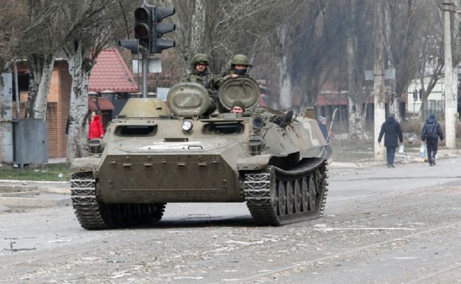 Service members of pro-Russian troops are seen atop of an armoured vehicle, which moves along a street in the course of Ukraine-Russia conflict in the southern port city of Mariupol, Ukraine April 1, 2022. REUTERS/Alexander Ermochenko