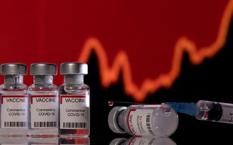 FILE PHOTO: Vials labelled "VACCINE Coronavirus COVID-19" and a syringe are seen in front of a displayed graph in this illustration taken December 11, 2021. REUTERS/Dado Ruvic/Illustration/File Photo